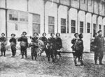 Workers carrying a gun manufactured at Jiangnan Arsenal, Shanghai, China, circa 1890