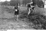 Members of the Hitler Youth laying field telephone wires in a military exercise, 1930s