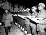 US Army Lieutenant General Joseph T. McNarney, Deputy Supreme Allied Commander in the Mediterranean Theater, inspecting African-American honor guard military policemen, Italy, 4 Jan 1945