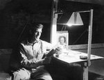 USAAF 3rd Bomb Group photographer George Tackaberry reading in his tent, Nadzab Airfield, Australian New Guinea, early 1944