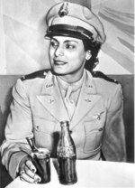 Willa Beatrice Brown, trainer for the US Army Air Forces, was the first African-American woman to receive commission as lieutenant in US Civil Air Patrol; note male-style coat and Germanic pilot wings