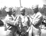 African-American US Army 2nd lts. Henry Harris, Frank Frederick Doughton, Elmer B. Kountze, and Rogers H. Beardon pinning on their new brass rank insignias, Ft. Benning, Georgia, US, 29 May 1942