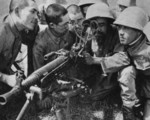Japanese Army personnel studying an anti-aircraft machine gun, circa 1940s