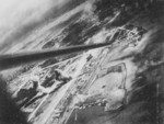 View of Toshien (now Zuoying) harbor and airfield, Takao (now Kaohsiung), Taiwan, 12 Oct 1944, photo 2 of 3; photo taken from aircraft of USS Wasp