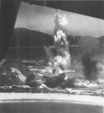 Suo (now Suao) harbor under attack by a PB4Y-1 aircraft of US Navy squadron VPB-104, eastern Taiwan, 22 Apr 1945, photo 1 of 4
