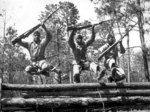 Three African-American United States Marine Corps recruits running the obstacle course at Camp Lejeune of Montford Point Camp, North Carolina, United States, Apr 1943