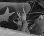 Female US Marines unfolding the wing of an aircraft, Naval Air Technical Training Center, Norman, Oklahoma, United States, circa 1943