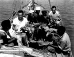 African-American MS2c Percy Hope, S1c Lilton Walker, and SC1c Jack Kelsen of USN 34th Construction Battalion trading with natives of Malaita at Halavo, Florida Island, Solomon Islands, 23 Sep 1943
