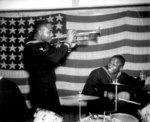 African-American US Navy Construction Battalion Coxswain Thomas J. Lindsey (trumpeter) and Seaman 1st Class Edward A. Grant (drummer) playing in England, United Kingdom, 14 Dec 1944