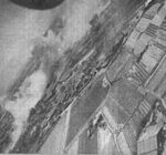 Kagi rail marshalling yard viewed by a B-25 bomber of USAAF 405th Bombardment Squadron during an attack, Taiwan, 3 Apr 1945, photo 1 of 2
