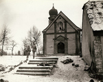 Two-man US patrol entering a church shortly after fighting had taken place, Europe, 1944-1945; note fallen soldiers