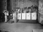 Stage singer Josephine Baker singing the American national anthem before an African-American US Army band directed by Technical Sergeant Frank W. Weiss, Municipal Theater, Oran, Algeria, 17 May 1943