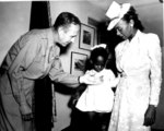 US Army BrigGen Robert N. Young presenting the Silver Star medal to the widow and daughter of African-American 1st Lt John W. Madison of 92nd Division, who was killed in Italy, date unknown