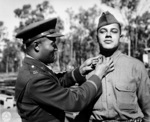 African-American US Army Captain E. H. Lowe pinning the 2nd Lieutenant insignia on James B. Morris, Camp Columbia, Brisbane, Australia, 29 Jun 1943