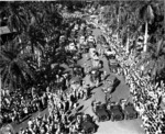 Returning Japanese-American veterans of US 442nd Regimental Combat Team parading through the the Iolani Palace grounds, Honolulu, US Territory of Hawaii, 9 Aug 1946
