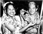 Japanese-American soldier of US 442nd Regimental Combat Team receiving a lei from a member of a welcoming committee, Honolulu, US Territory of Hawaii, 9 Aug 1946
