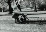 Dutch children stealing wood from tram tracks for use as fuel in kitchen stoves, 5 May 1945