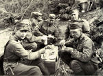 Finnish Army Colonel Wahlbeck (far right), Lieutenant Colonel Swendelin (behind Wahlbeck), and other officers taking a break in the field during the Äyräpään-Vuosalmen campaign, Karjala, Finland, Jun-Jul 1944