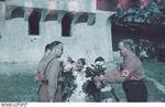Nazi German officials purchasing bouquets of flowers from Sinti or Roma women, Bucharest, Romiania, circa 1941