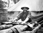 Private Jack David of the US Army Engineer task force scrubbing out his belongings, Liberia, Jul 1942