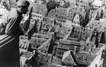 A German soldier looking at Strasbourg, France from the tower of the city