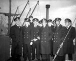African-American crew of Liberty Ship SS Booker T. Washington after her maiden voyage, England, 8 Feb 1943; L to R: Lastic, Young, Hlubk, Blackman, Smith, Mulzac, Fokes, Kruley, Rutland, Larson