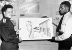 Russian Army Captain Orset Chevstov receiving a painting from African-American merchant seaman and artist George Wright, 18 Aug 1944; note painting theme of Russo-American cooperation