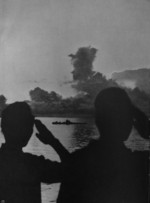 Two Japanese sailors saluting at vessels in the distance, 1941-1943