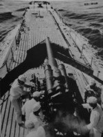 View of the deck and deck gun of a surfaced Japanese submarine, 1941-1943