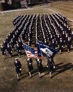 Trainees of US Naval Training Center, Hunter College, Bronx, New York, United States marching in formation behind their color guard, during WW2