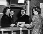 WAVES personnel receiving mail from Postmistress Mrs. Jan Phillips, circa 1944