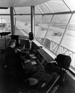 WAVES Control Tower Operator at work at  Naval Air Station, Floyd Bennett Field, New York, United States, Nov 1943; note FM Wildcat and TBM Devastator aircraft in background