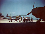 WAVES and Women Marines mechanics marching, Naval Air Station, Norfolk, Virginia, United States, circa 1944-1945; note PBM-3D, OS2U, and TBM aircraft