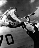 Ensign Mary McLean gave her hat to another WAVES officer as she boarded a training aircraft for an orientation flight, Naval Air Station, Squantum, Massachusetts, United States, Oct 1943