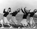 WAVES personnel serving as cheerleaders for the football team of Naval Air Station, Ottumwa, Iowa, United States, 21 Oct 1943. L to R: Virginia Gervais, Dorothy Nicoll, Mary Kneller, and Nancy Lanford