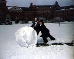 WAVES Seaman 2nd Class Mary Swamberger and Seaman 2nd Class Dorothy Gasperi rolling a snowball at the Yeoman Training School, Iowa State College, Cedar Falls, Iowa, United States, 1944