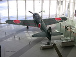 A6M Zero Model 52 fighter on display at the Yushukan Museum, Tokyo, Japan, 7 Sep 2009, photo 5 of 5; note Type 99 20-mm aircraft cannon in display case and special attack pilot statue outside