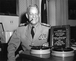 Admiral Burke in his Pentagon office, posing with the 