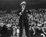 Admiral Burke addressing an US Naval Academy pep rally, 23 Nov 1960, on the eve of the Army-Navy football game