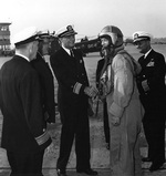 Burke, in flight suit, arrived at Naval Air Station Glenview, Illinois, US aboard an A3D jet bomber, 15 Sep 1955; meeting him were VAdm Doyle, RAdm Gallery, RAdm Forrestel, and Capt Hollingsworth