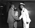Japanese Admiral (ret.) and former Ambassador to United States Nomura shaking hands with American Rear Admiral Burke aboard cruiser Los Angeles in Japanese waters, 22 Jun 1951