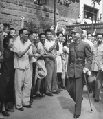 Chiang Kaishek greeted by a crowd after announcing the Japanese surrender at the Central Broadcasting System facilities in Chongqing, China, 15 Aug 1945