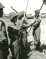US 5th Army Lieutenant General Mark Clark pinning Presidential Distinguished Unit Citation ribbons to Japanese-American members of 100th Infantry Battalion, Vada area, Italy, 27 Jul 1944