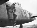 Prime Minister John Curtin exiting from Lancaster bomber 