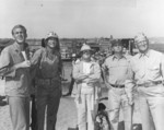 Actor Forrest Tucker, actor John Wayne, director Allan Dwan, Major General Graves Erskine, and others during the filming of the movie Sands of Iwo Jima, 1 Jan 1949