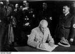 Frick signing a document, Sudetenland, Czechoslovakia, 23 Sep 1938