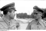 German Luftwaffe Major General Adolf Galland speaking to Colonel Günther Lützow while inspecting an airfield in southern Italy, circa summer 1943