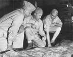Major General Roy Geiger, Colonel Merwin Silverthorn, and Brigadier General Pedro del Valle studying Guam terrain aboard USS Appalachian, mid-1944