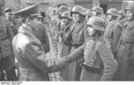 Joseph Goebbels shaking hands with Hitler Youth member Willi Hübner, who had just received the Iron Cross 2nd Class medal for bravery in combat, East Prussia, Germany, 9 Mar 1945