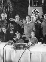 Joseph Goebbels with daughters Helga and Hilde at a large Christmas party amidst the playing of a patriotic song, 23 Dec 1937